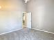 Neutral bedroom featuring plush carpet and natural light peering through an open doorway at 1525 Oakwood Ct, Apopka, FL 32703