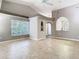 Spacious living room with tile floors, vaulted ceiling, and large window at 1525 Oakwood Ct, Apopka, FL 32703