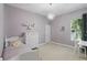 Bedroom featuring a decorative chandelier, bed, dresser, window, and desk with chair at 1601 Pink Dogwood Way, Oviedo, FL 32765