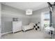 Charming bedroom with light gray walls, striped accent, and ample natural light from the nearby window at 1601 Pink Dogwood Way, Oviedo, FL 32765