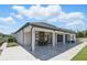 Spacious outdoor patio area with covered seating and modern architecture that offers stylish outdoor living at 1601 Pink Dogwood Way, Oviedo, FL 32765