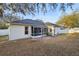 View of the back of the house featuring a screened-in patio and a spacious backyard at 1601 Stoneywood Way, Apopka, FL 32712