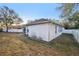 Spacious backyard featuring a screen porch and a white privacy fence at 1601 Stoneywood Way, Apopka, FL 32712