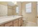 Bright bathroom with white tile, vanity, and shower/tub combo at 1601 Stoneywood Way, Apopka, FL 32712