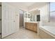 Bright bathroom featuring a shower, bathtub, neutral tiling, and wooden vanity at 1601 Stoneywood Way, Apopka, FL 32712