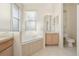 Bright bathroom featuring a garden tub, neutral tiling, vanity, and natural light at 1601 Stoneywood Way, Apopka, FL 32712