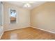 A vacant bedroom featuring natural light, a ceiling fan, and hardwood floors at 1601 Stoneywood Way, Apopka, FL 32712