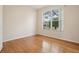 Bright bedroom with hardwood floors, window view and neutral walls at 1601 Stoneywood Way, Apopka, FL 32712