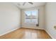 Bright bedroom featuring hardwood floors and a large window offering natural light at 1601 Stoneywood Way, Apopka, FL 32712