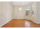 Bright dining room with hardwood floors, chandelier, and windows at 1601 Stoneywood Way, Apopka, FL 32712