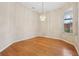 Inviting dining room highlighting hardwood floors, natural light, and a stylish chandelier at 1601 Stoneywood Way, Apopka, FL 32712