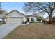 Charming single-Gathering home featuring a manicured lawn, mature landscaping, and an attached two-car garage at 1601 Stoneywood Way, Apopka, FL 32712