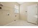 Practical laundry area with tile flooring, shelving, and utility connections at 1601 Stoneywood Way, Apopka, FL 32712