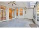 Enclosed patio with ceiling fan and multiple entry/exit points to the home and backyard at 1601 Stoneywood Way, Apopka, FL 32712