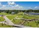 Aerial image of park featuring ponds, pedestrian bridges, walking paths and lush green space at 1670 Blue Lagoon Cir, Mascotte, FL 34753