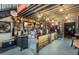 Inviting bar area featuring a rustic wood counter, industrial lighting, and lively decor for a social atmosphere at 1676 Blue Lagoon Cir, Mascotte, FL 34753