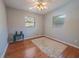 A clean bedroom with hardwood floors, dual windows, and a modern ceiling fan at 1700 Edmundshire Rd, Orlando, FL 32812