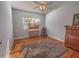 A well-appointed bedroom featuring hardwood floors, a window, and a ceiling fan at 1700 Edmundshire Rd, Orlando, FL 32812