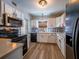 Bright, updated kitchen featuring stainless appliances, white cabinets, modern hardware, and stylish backsplash at 1700 Edmundshire Rd, Orlando, FL 32812