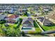 Gorgeous aerial shot of a home featuring a pool, solar panels, pristine landscaping, and in a Gathering-friendly community at 1740 Standing Rock Cir, Oakland, FL 34787