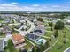 An aerial view of neighborhood homes that feature pools, solar panels, and well maintained landscaping at 1740 Standing Rock Cir, Oakland, FL 34787