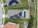 Aerial view of a private backyard pool and patio with solar panels at 1740 Standing Rock Cir, Oakland, FL 34787