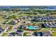 Nice aerial view of a neighborhood showing the community pool, lake in the background, and solar panels at 1740 Standing Rock Cir, Oakland, FL 34787