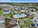 Aerial view of a community pool, playground, and homes at 1740 Standing Rock Cir, Oakland, FL 34787