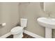 Powder room featuring wood-style floors, a pedestal sink and toilet at 1740 Standing Rock Cir, Oakland, FL 34787