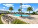 Community pool with lounge chairs, surrounded by palm trees, offering a tropical resort-style living experience at 1740 Standing Rock Cir, Oakland, FL 34787