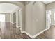 Hallway features wood-look tile flooring, white trim, and arches to other rooms at 1740 Standing Rock Cir, Oakland, FL 34787