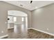 Open-concept living room featuring arched doorways, wood-look tile flooring, and abundant natural light at 1740 Standing Rock Cir, Oakland, FL 34787