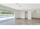 Bright open-plan living area with wood-look tile flooring and large sliding doors leading to the pool area at 1740 Standing Rock Cir, Oakland, FL 34787