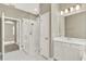 Bathroom featuring a glass door shower, white tile and vanity with lighting at 1740 Standing Rock Cir, Oakland, FL 34787