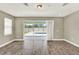 Bright living room with sliding glass doors leading to the outdoor pool area at 1740 Standing Rock Cir, Oakland, FL 34787