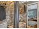 Bathroom featuring gray tiled shower/tub with neutral gray walls, tile and view into bedroom at 1800 Wycliff Dr, Orlando, FL 32803