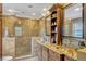 Luxurious bathroom with double vanity, granite countertops, and stone-tiled shower with glass enclosure at 1800 Wycliff Dr, Orlando, FL 32803