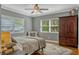 Comfortable bedroom featuring a ceiling fan, chair, area rug and plenty of natural light at 1800 Wycliff Dr, Orlando, FL 32803