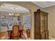 Dining room with a large table, chandelier and an antique cabinet by a window at 1800 Wycliff Dr, Orlando, FL 32803