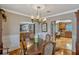 Formal dining room showcasing wood floors, chandelier, and arched doorways to other rooms at 1800 Wycliff Dr, Orlando, FL 32803