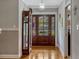 Inviting entryway featuring hardwood floors and a beautiful, large, wooden front door at 1800 Wycliff Dr, Orlando, FL 32803