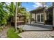 A hot tub sits under a pergola in a secluded corner of the backyard and wooden patio at 1800 Wycliff Dr, Orlando, FL 32803