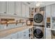 Well-organized laundry room featuring modern washer and dryer, ample storage, and stylish decor at 1800 Wycliff Dr, Orlando, FL 32803