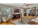 Cozy main bedroom features a decorative rug, ceiling fan, television, and ample natural light at 1800 Wycliff Dr, Orlando, FL 32803