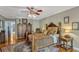 Warm and inviting main bedroom featuring a decorative rug, ceiling fan and wooden furniture at 1800 Wycliff Dr, Orlando, FL 32803