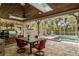 A covered outdoor kitchen and dining area are situated next to the pool with a full view of the backyard at 1800 Wycliff Dr, Orlando, FL 32803