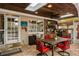 Entertaining outdoor kitchen featuring stainless steel appliances, a dining table, and a wood ceiling at 1800 Wycliff Dr, Orlando, FL 32803