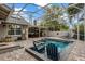 A beautiful screened-in pool area features plenty of room to relax and enjoy the outdoor kitchen at 1800 Wycliff Dr, Orlando, FL 32803