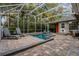 A beautifully-designed screened-in pool area with plenty of seating and pavers to enjoy the outdoors at 1800 Wycliff Dr, Orlando, FL 32803