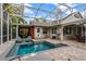 A beautiful screened-in pool area features plenty of room to relax and enjoy Florida's warm weather at 1800 Wycliff Dr, Orlando, FL 32803